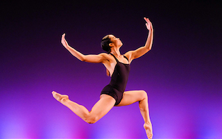 Female dancer in air with pointed toes