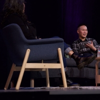 Actor BD Wong sits in a chair on a stage across from a woman