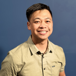 Asian male wearing a tan collared shirt