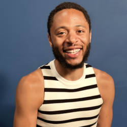 person wearing a black and white striped tank, they are smiling