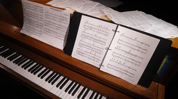 Piano with music sheets